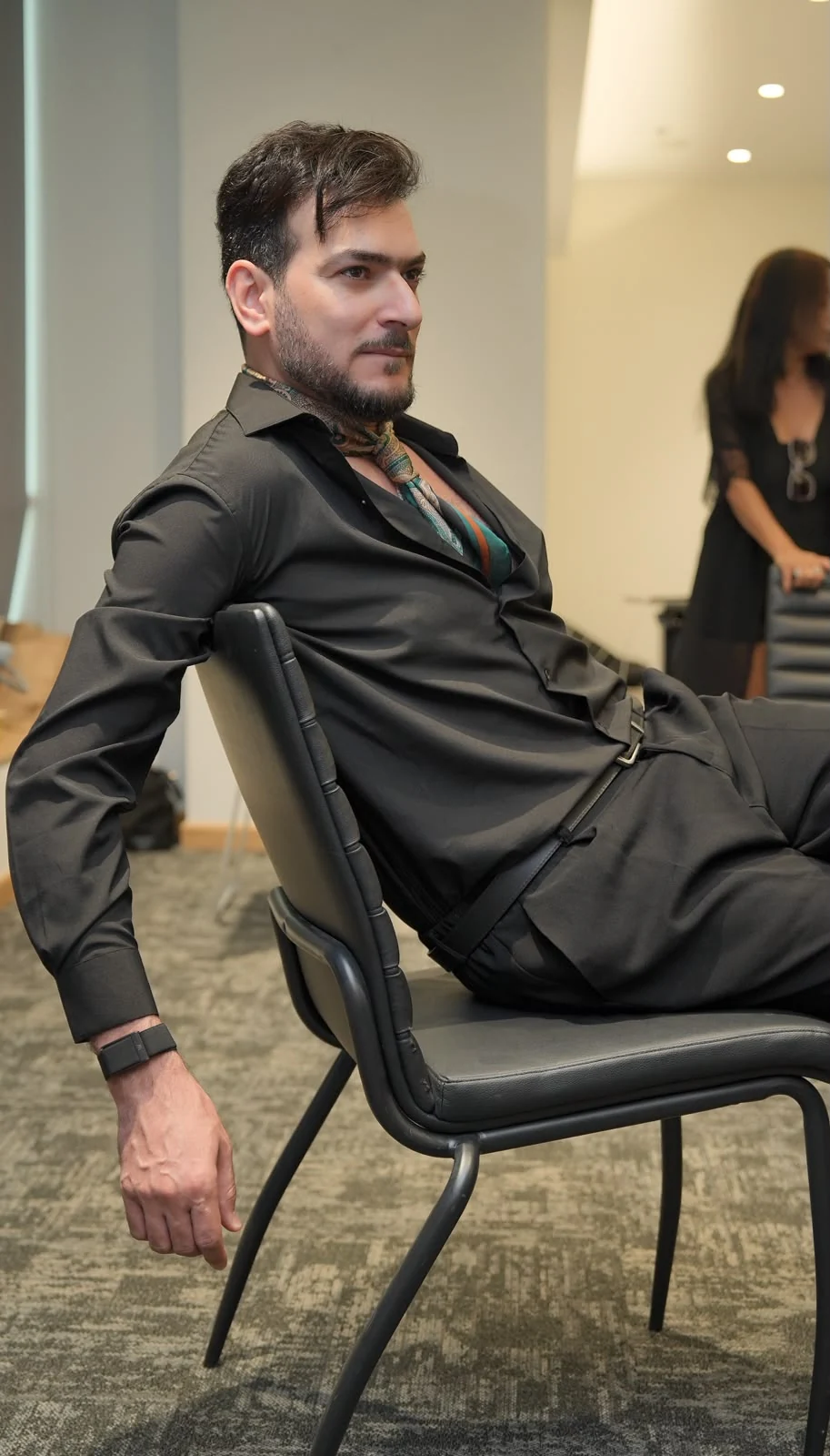 A participant practising camera presence with a seated pose.