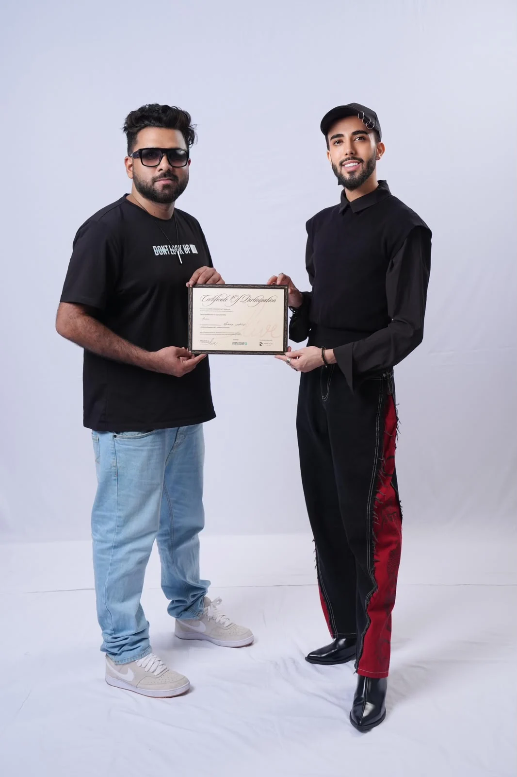A participant and instructor holding a certificate of participation.