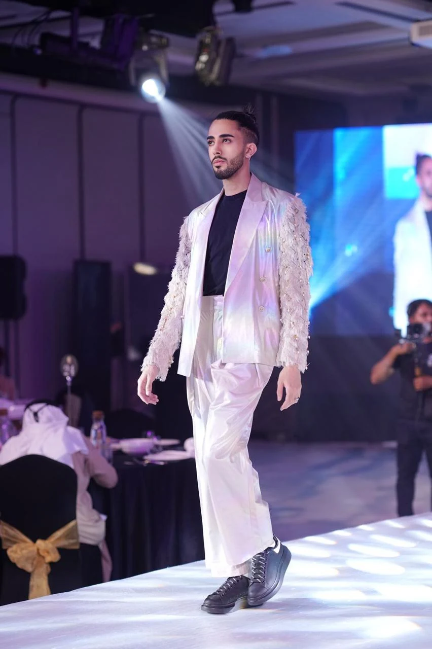 A model presenting a lilac outfit on a fashion runway.