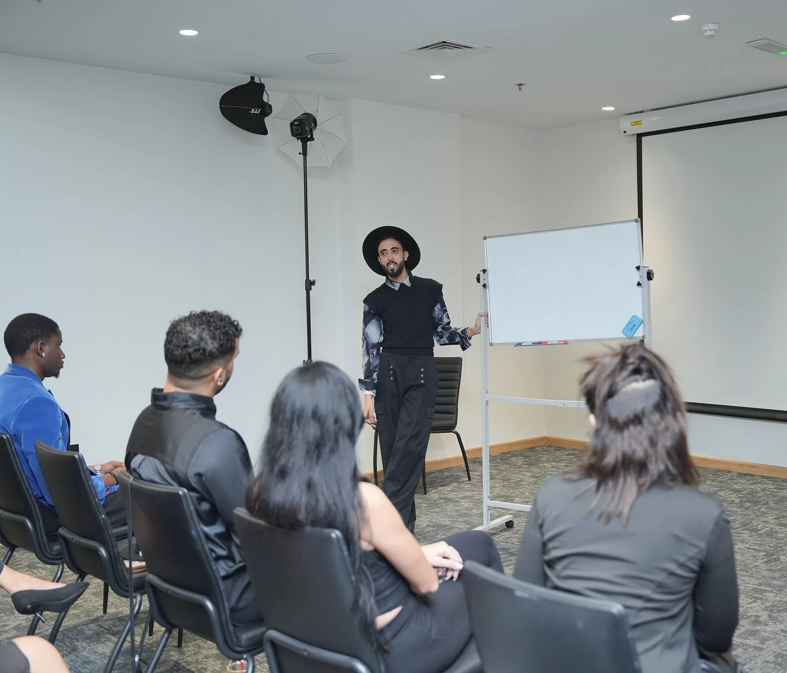 Students attending an academy classroom session led by the coach.